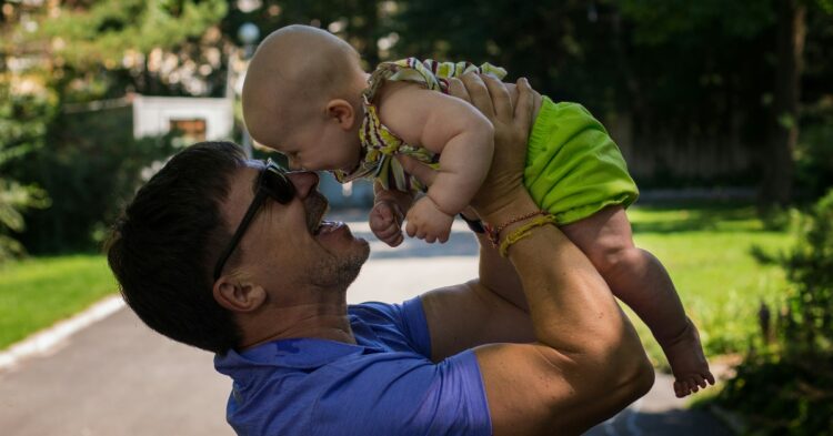 Father-holding-baby-Unsplash-Juliia-Abramova-1-750x393